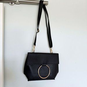 Black cross body purse with large gold ring detail | Pleather